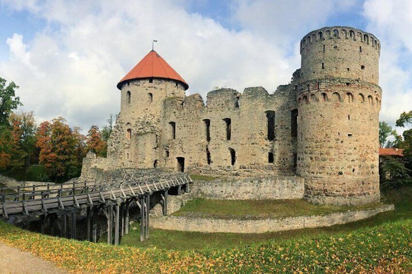 A medieval castle with a round tower and a wooden bridge. 5