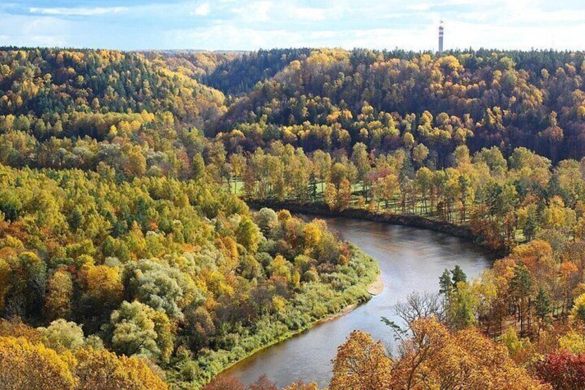 A river winding through a forested valley with autumn foliage. 2