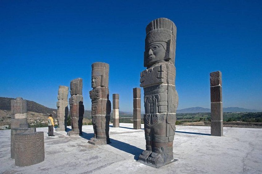 Ancient stone statues in a desert landscape. 1