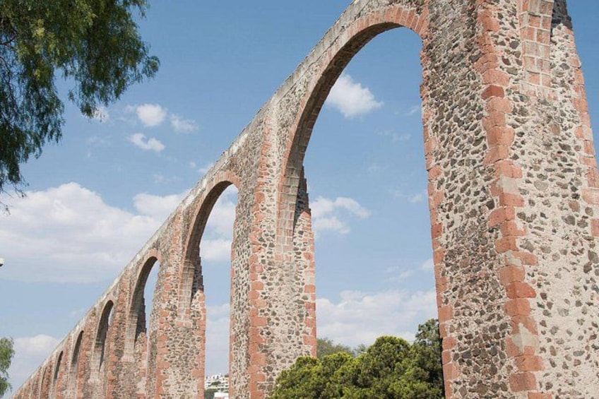 A series of stone arches with a brick pattern, likely part of an old bridge or aqueduct. 5