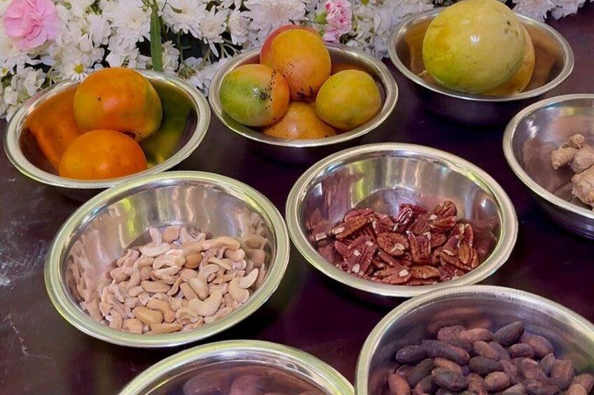 Bowls of various nuts and fruits on a table. 3