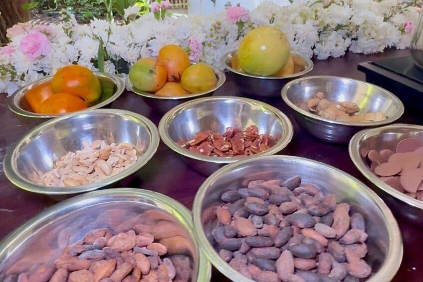 A table with various bowls containing fruits and nuts. 2