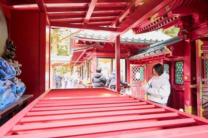 A red-roofed building with traditional architecture, a person in a white jacket, and a blue sculpture. 3