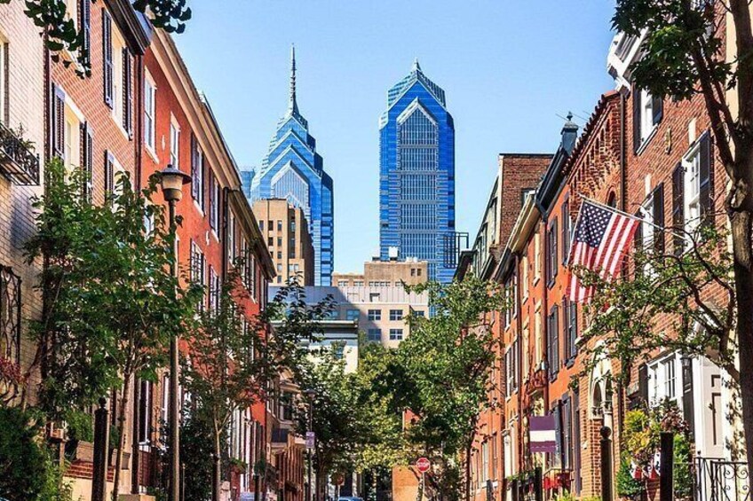 A street lined with historic buildings and a modern skyscraper. 2