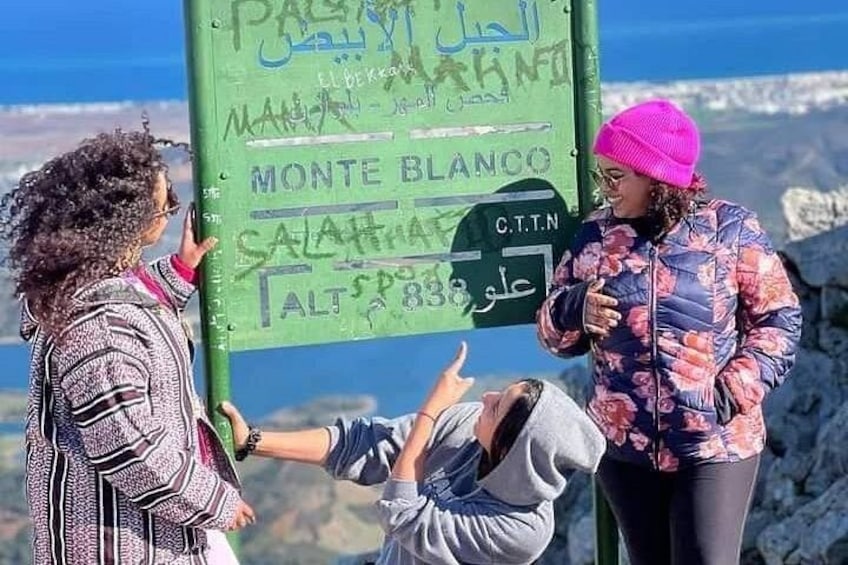 A sign with text in multiple languages, including Arabic and English, indicating a location. 5