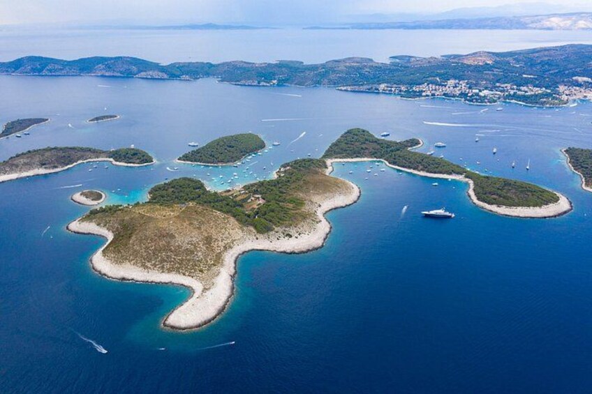 An aerial view of a coastal area with multiple islands and clear blue waters. 1