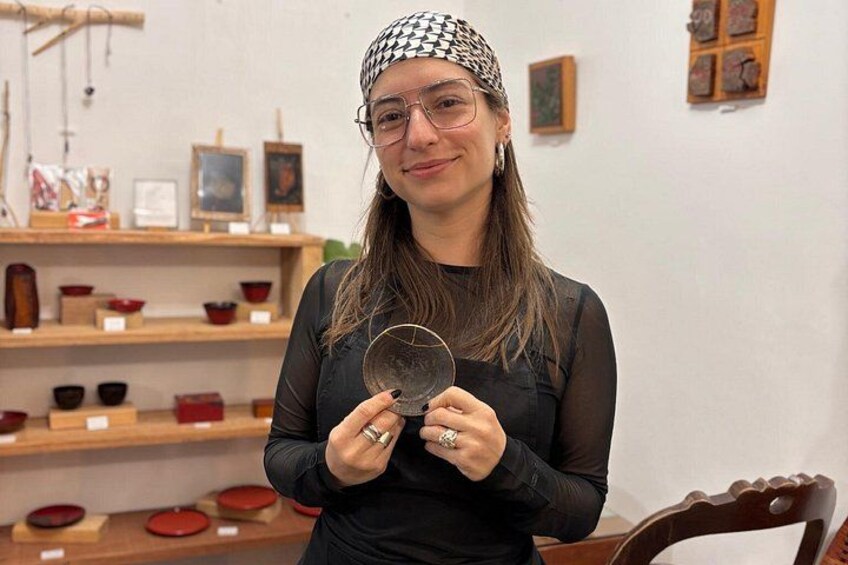 A person holding a circular object, standing in a room with shelves displaying various items. 4