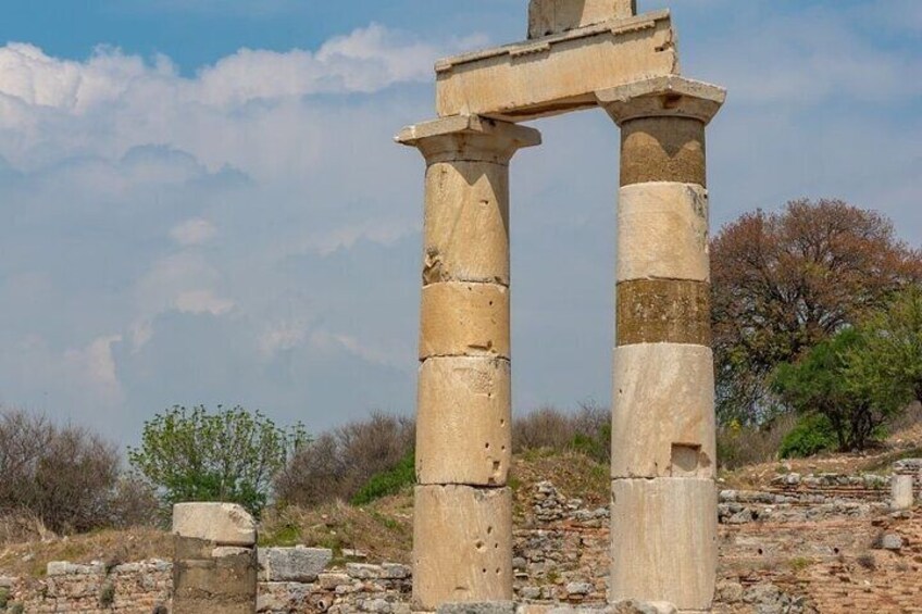 Ancient stone columns with a clear sky in the background. 2