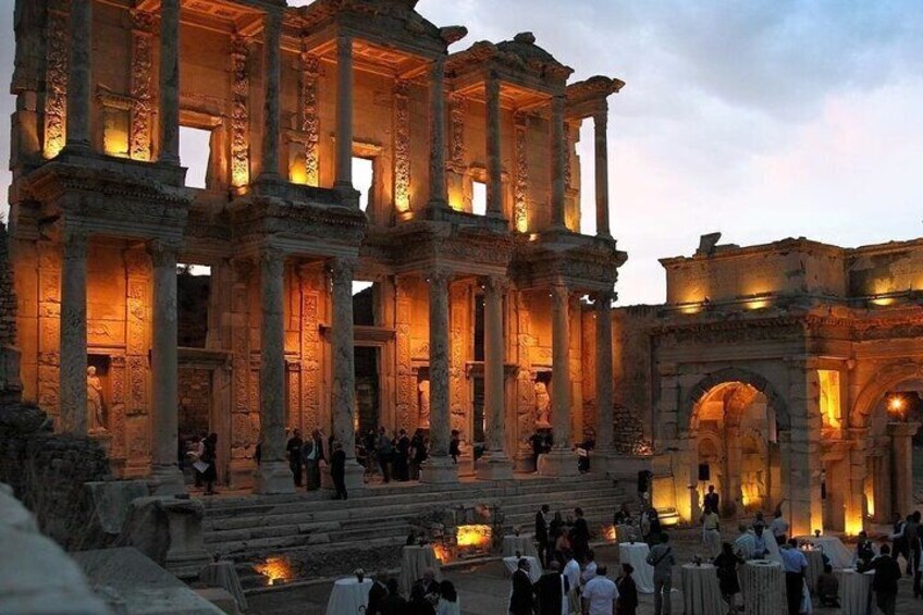 Ancient ruins with columns and arches, illuminated by warm lights. 4