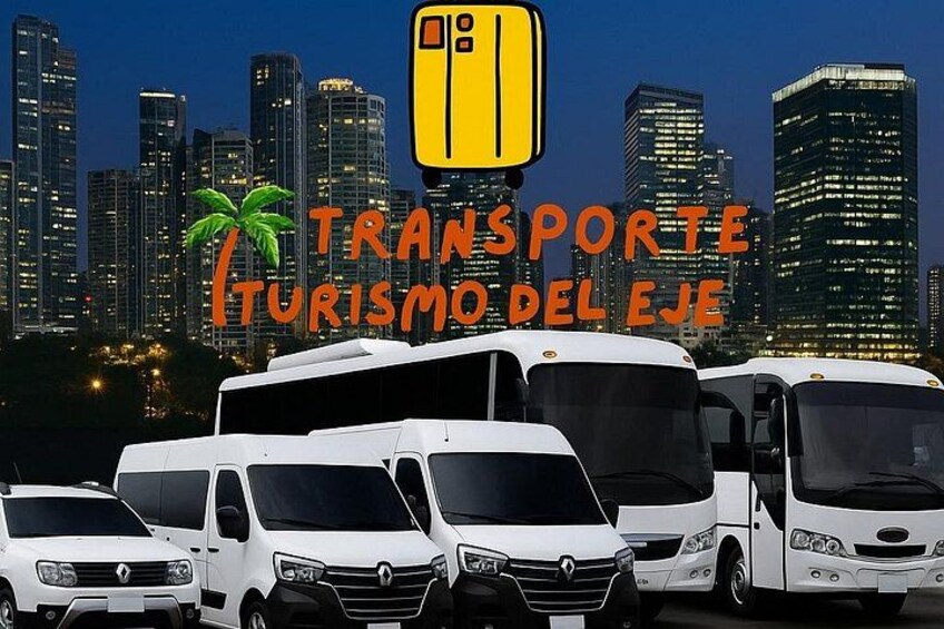 A fleet of white tour buses parked in front of a city skyline at night. 3
