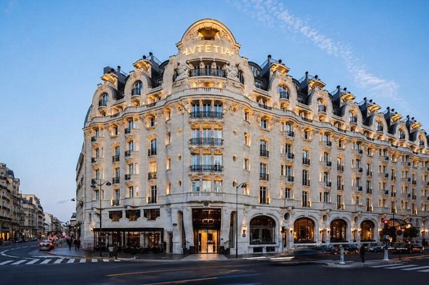 A grand, ornate building with a large arched entrance and multiple balconies. 5