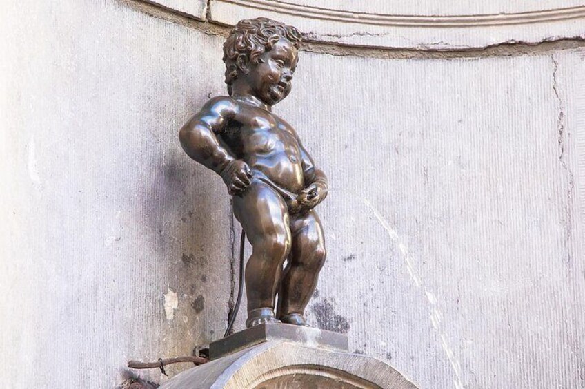 A bronze statue of a cherub on a pedestal. 2