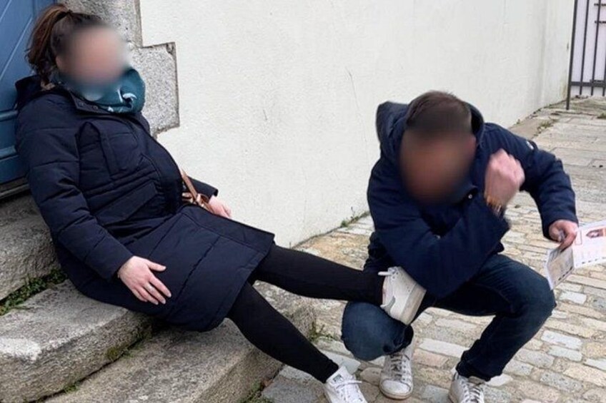 Two people sitting on stone steps, one holding a book. 4