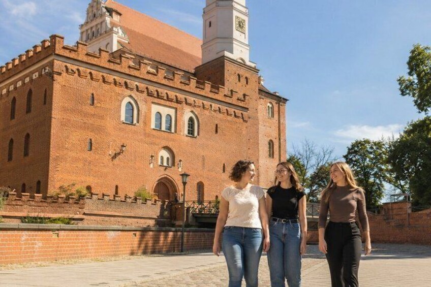 A brick building with arched windows and a clock tower. 3