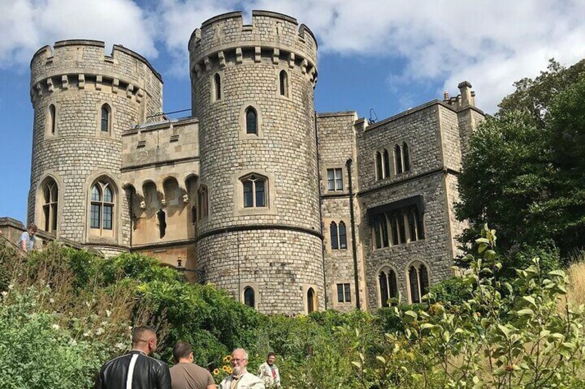A large stone castle with two round towers and arched windows. 1