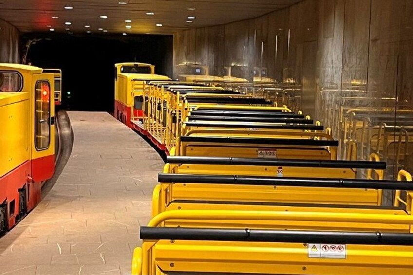 A train station with yellow trains and tracks. 2