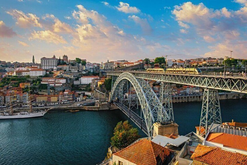 A bridge over water with buildings and a clear sky. 4
