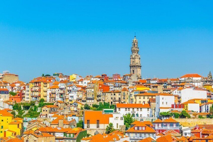 A densely packed urban area with a prominent tower and a variety of colorful buildings. 2