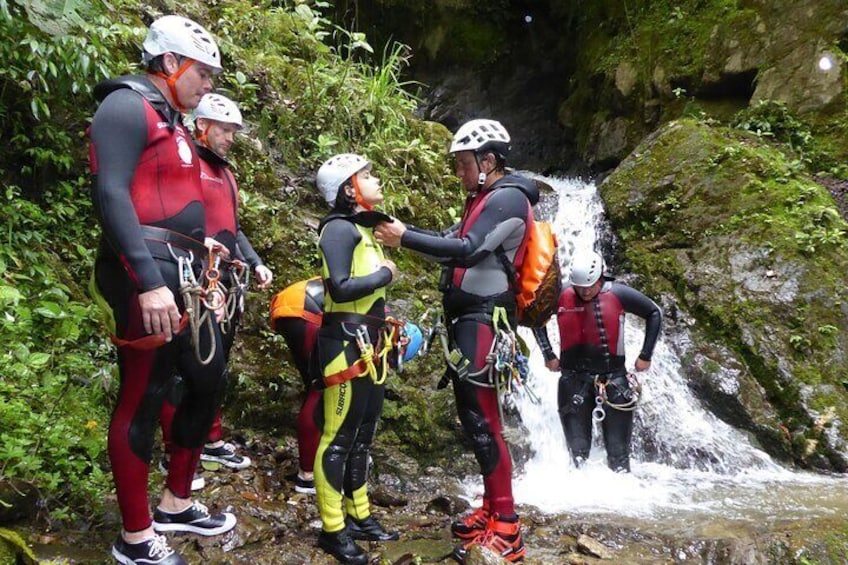 A group of people in outdoor gear near a waterfall. 5
