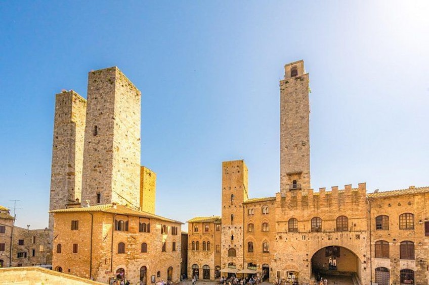 A historic stone building with two prominent towers and a central archway. 2