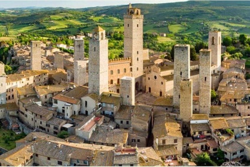 A medieval town with stone buildings and a prominent tower. 4
