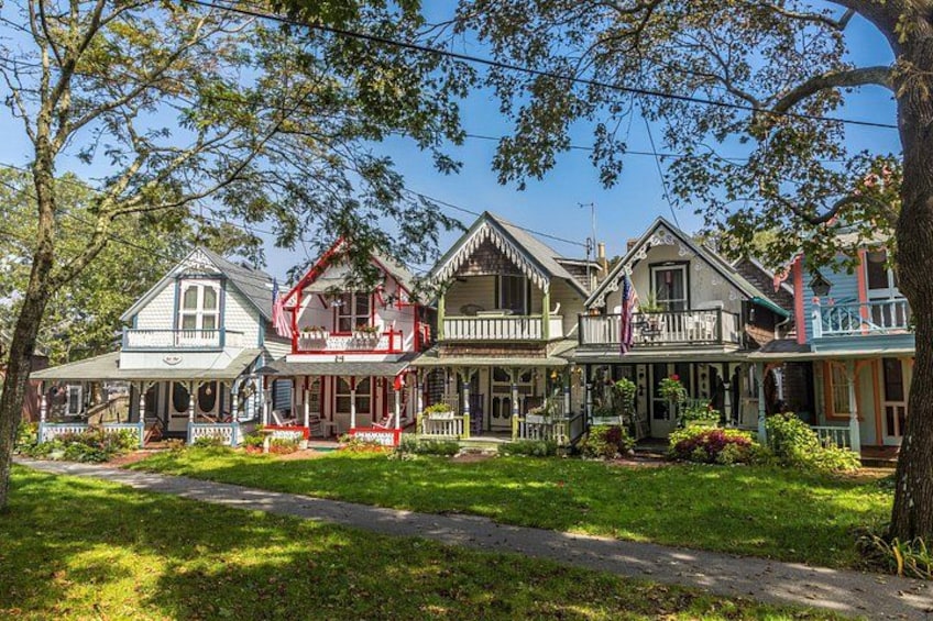 A row of colorful houses with a grassy lawn and a pathway. 2