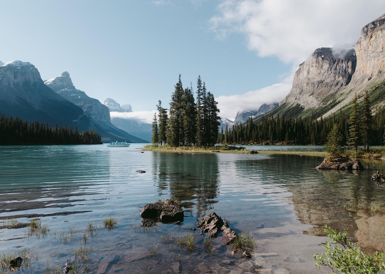 A calm lake surrounded by mountains and dense forests. 2