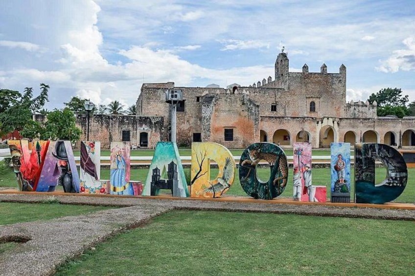 A historic building with murals and large letters spelling 'VANADOLID' in the foreground. 2