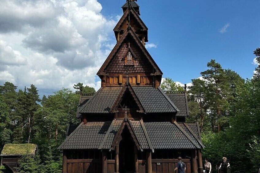 A wooden building with a steeply pitched roof and a bell tower. 3
