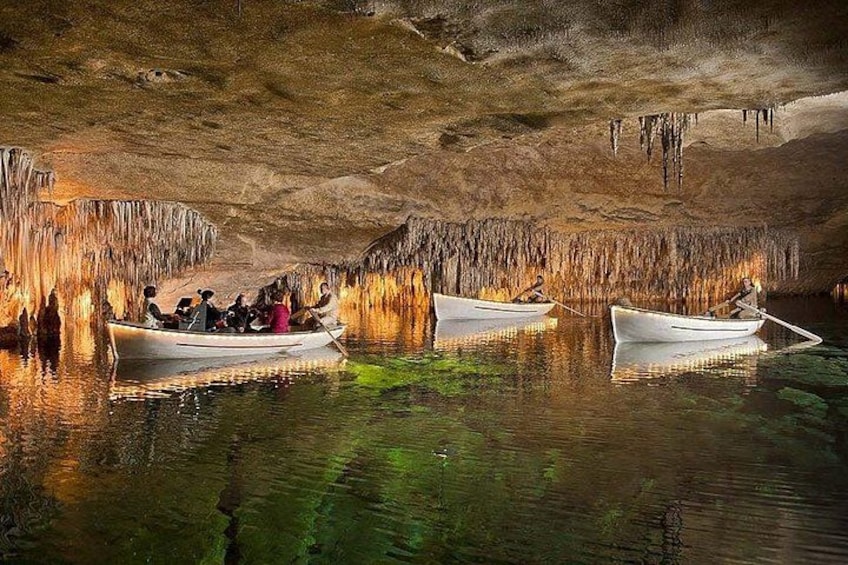 A cave with boats and people. 1