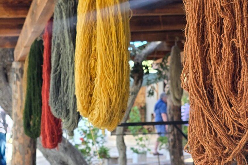Various colored ropes hanging from a wooden structure. 4