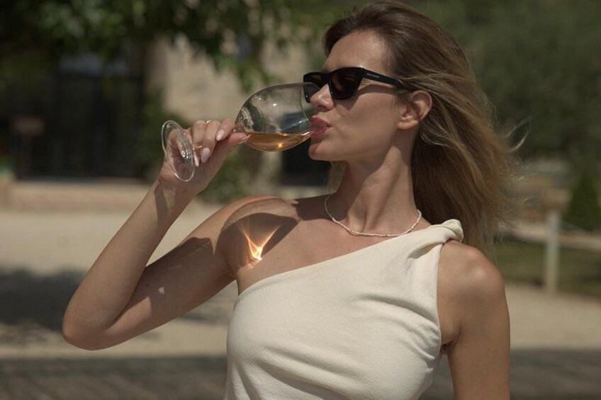 A person holding a wine glass. 5