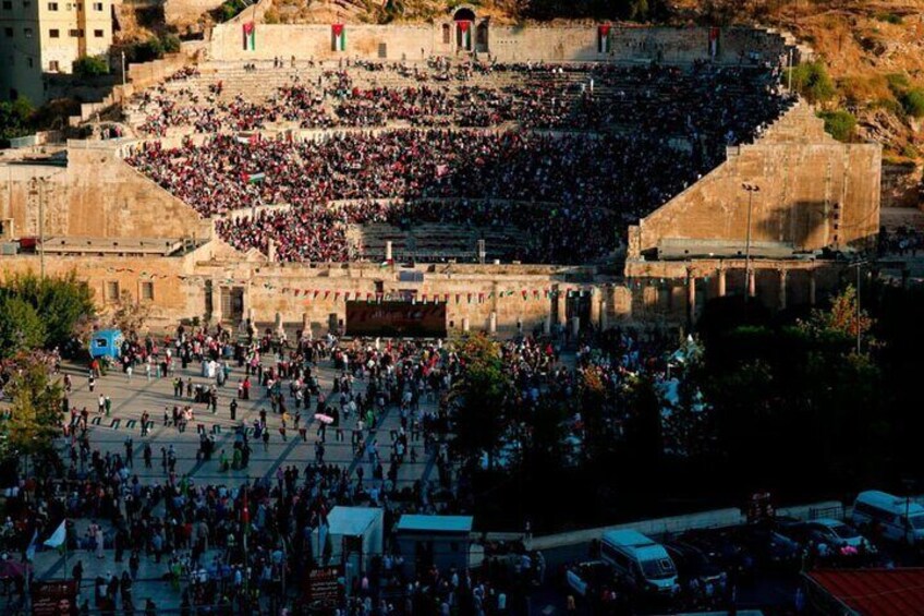 A large outdoor amphitheater filled with people. 3