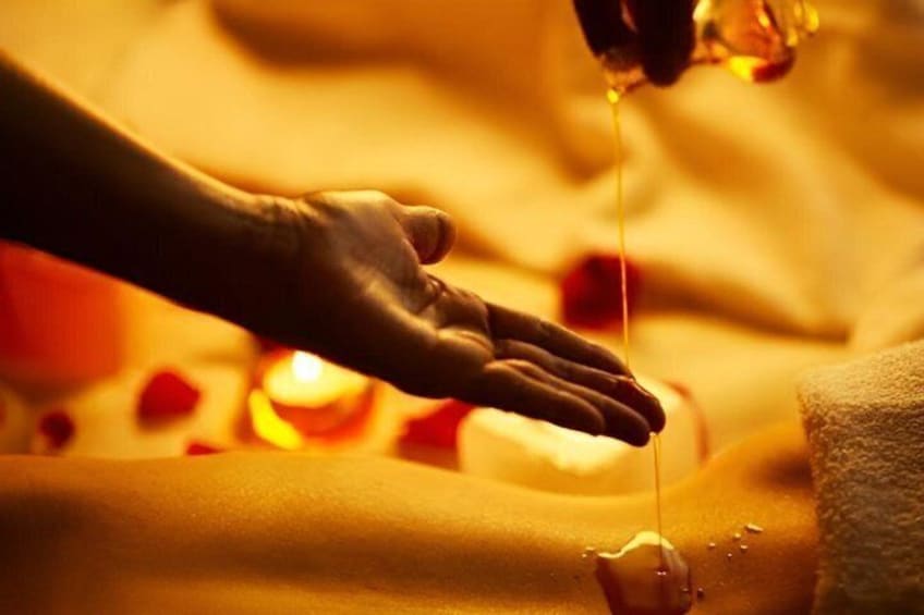 A hand receiving a massage with oil being applied. 2