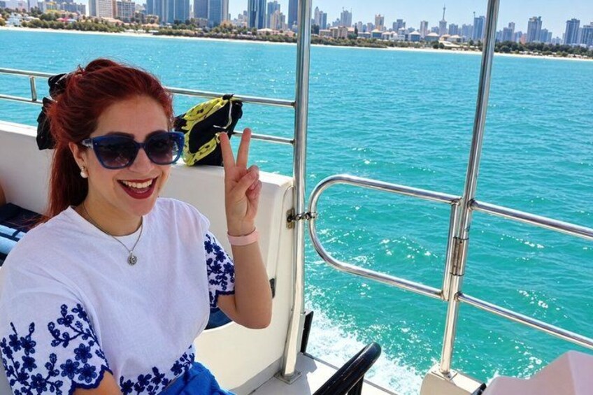 A person on a boat with a city skyline in the background. 5