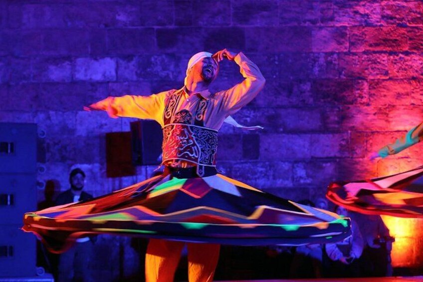 A person in a colorful, patterned outfit performing a dance. 5