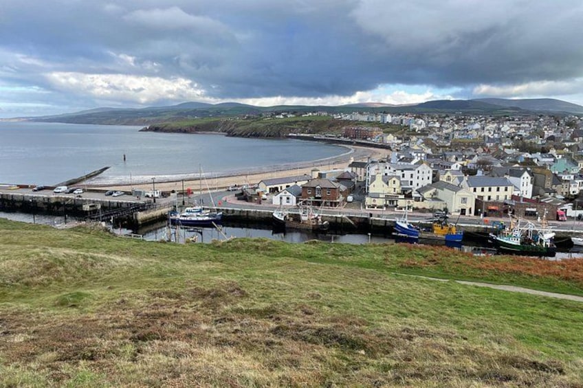 A coastal town with a harbor, boats, and buildings. 4