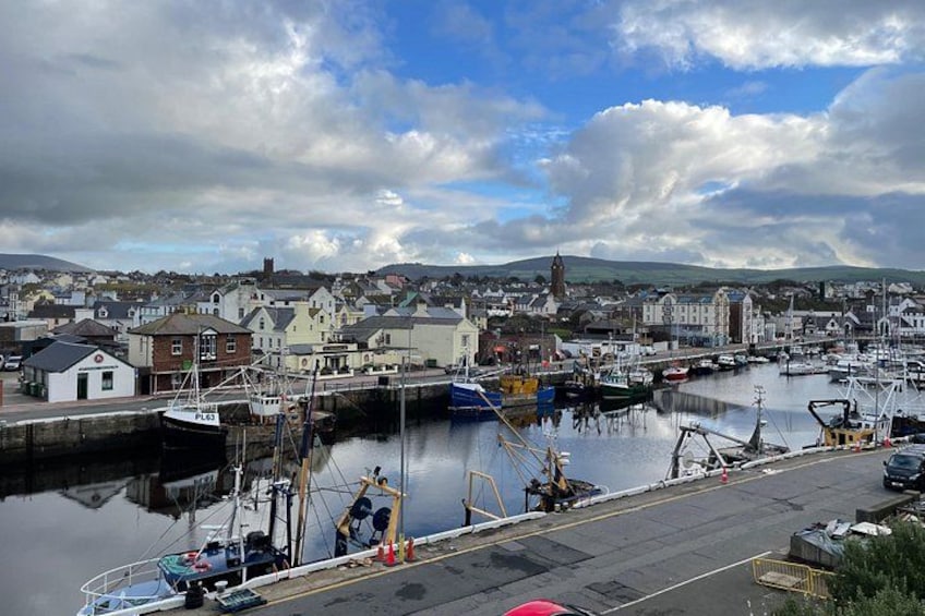 A harbor with boats, a dock, and buildings in the background. 5
