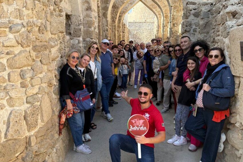 A group of people standing in a stone archway. 3