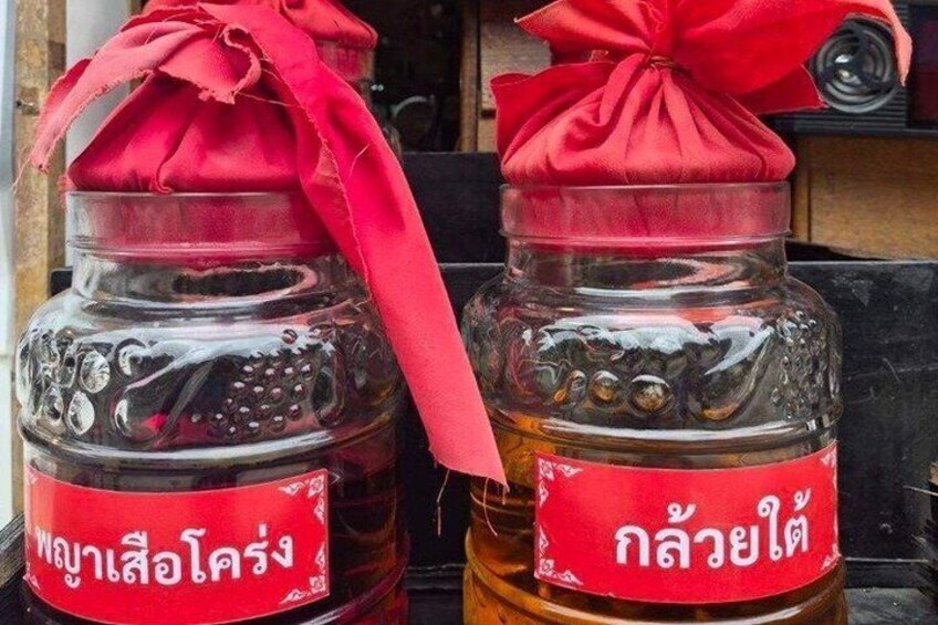Two glass jars with red labels and a red ribbon tied around them. 2