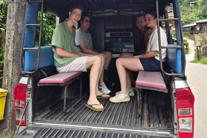 A vehicle with a rear view of passengers seated inside. 4