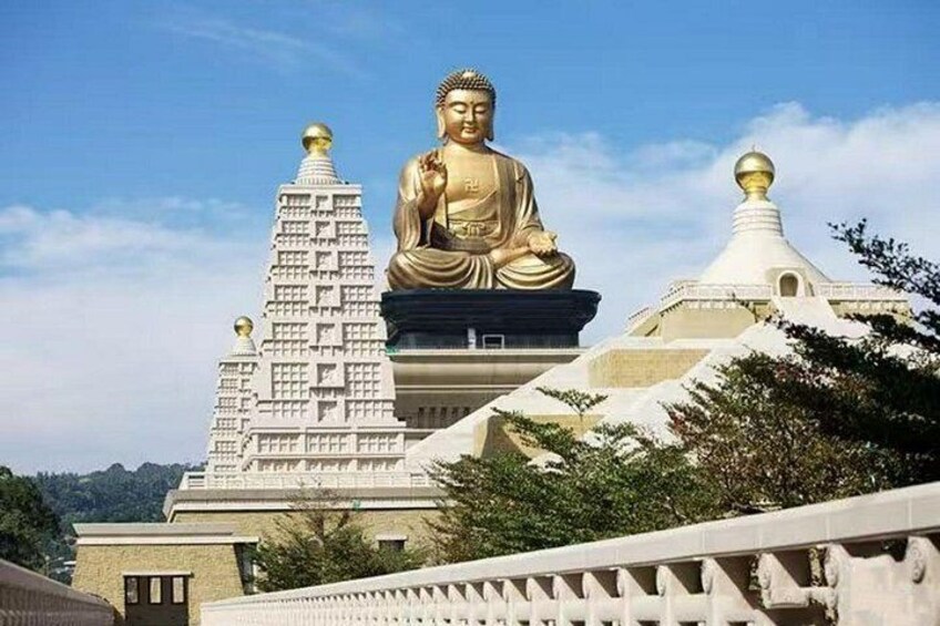 A large golden Buddha statue, a white temple with a spire, and a white pagoda with a golden dome. 3