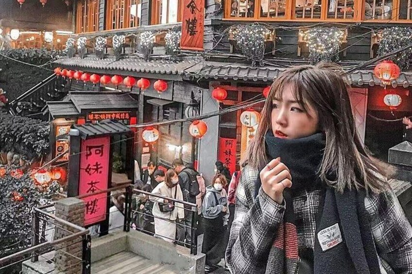 A traditional Chinese building with red lanterns and signage. 4