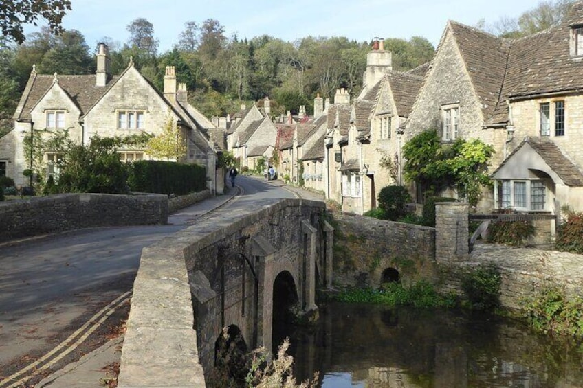 A stone bridge over a canal in a village with stone houses. 1