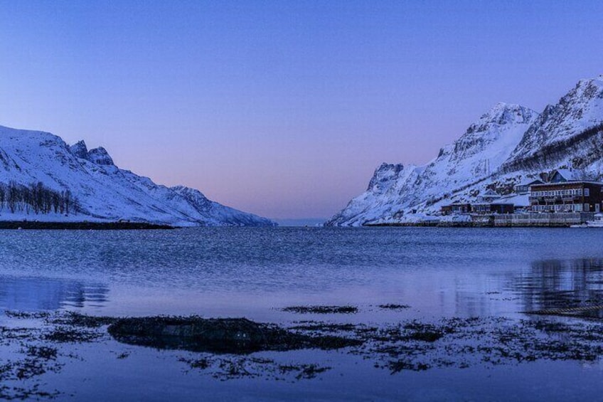 A snow-covered mountain range with a building on the right. 4