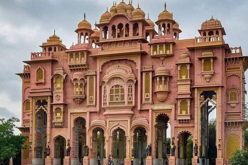 A pink palace with ornate architecture, including domes and arches, and a sign that reads 'Patna Gate'. 3