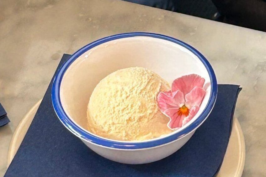 A bowl with a flower on a napkin. 5