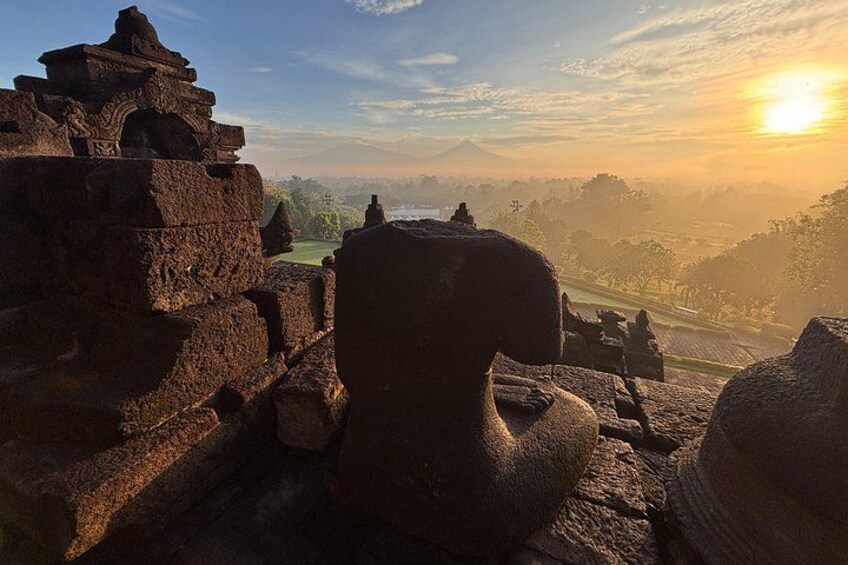 Ancient stone ruins with a sunset in the background. 5