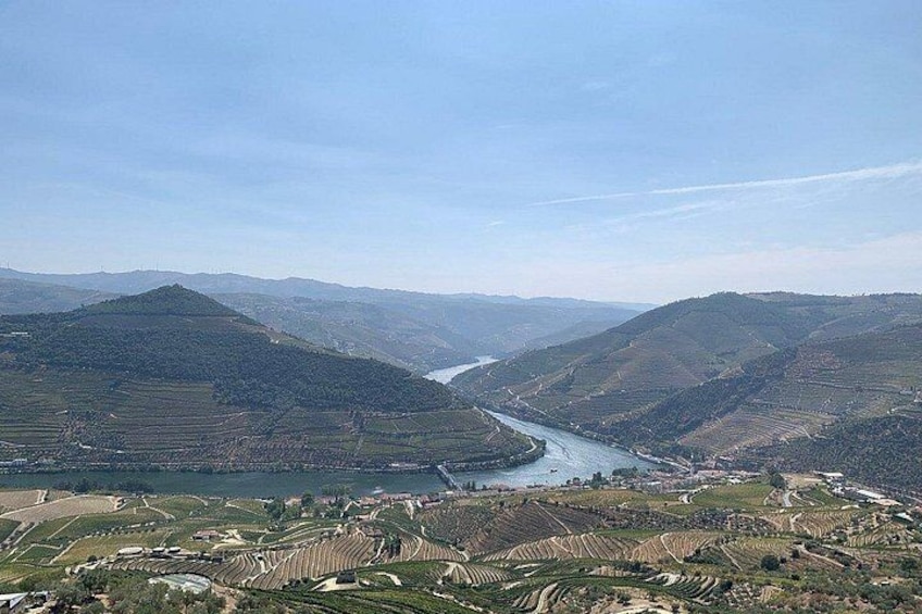 A river winding through terraced fields in a hilly landscape. 4