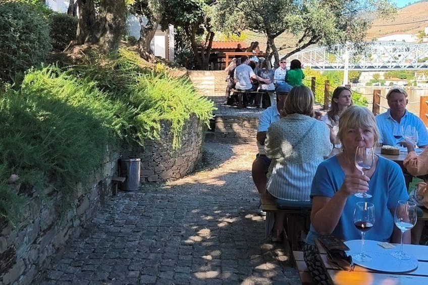A cobblestone path, outdoor seating, and people dining. 4